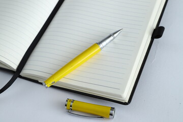 Business concept - Top view collection of black fly black notebook front, back and white open page, ballpoint pen isolated on background for mock up