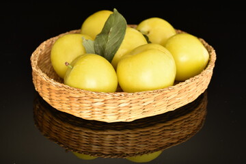 Ripe yellow plum, close-up, isolated on black.