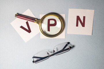 VPN Virtual Private Network word acronym on sticky notes paper with magnifying searching glass