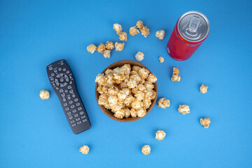 watching movie at home concept, cold refreshing red coca cola can, wooden bowl of fresh caramel...
