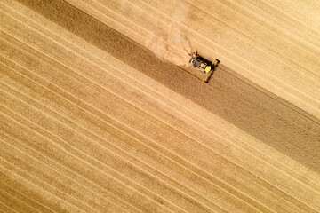 aerial view of a modern combine harvester in action ending harvesting a wheat field