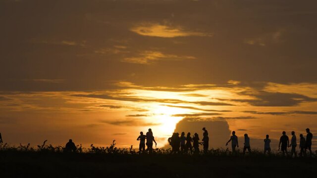 Silhouette of crowded people enjoying sunset view