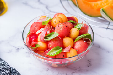 Fruit salad with melon cantaloupe, watermelon and prosciutto