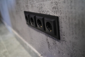Black rosette on Power outlet wall. Home and office repair