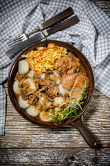 Stewed pork chop in a bright mushroom sauce.