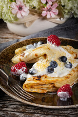Pancakes with white cheese and fruit.