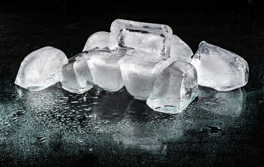 Cool cold Ice cubes on a black surface