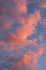 beautiful photo of the blue sky and clouds painted pink by the sunset