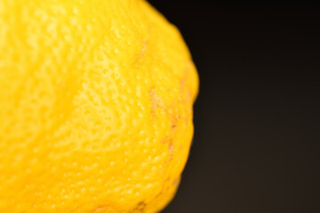 Naklejka na ściany i meble Ripe yellow lemons, close-up, on a black background.