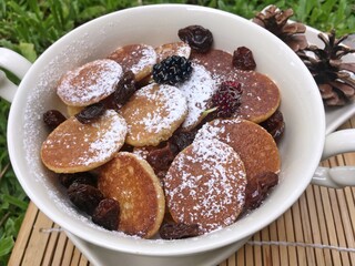 Mini pancake with raisin in the bowl