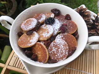 Mini pancake with raisin in the bowl