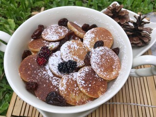 Mini pancake with raisin in the bowl