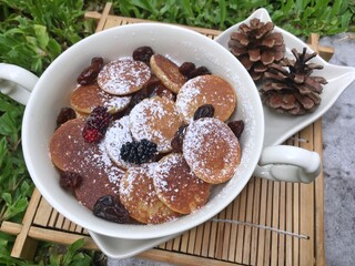 Mini pancake with raisin in the bowl