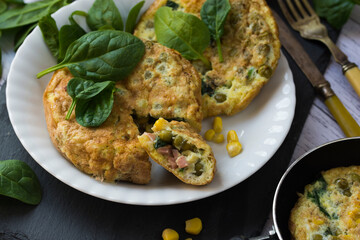 An omelette with sweet corn, green peas and spinach.