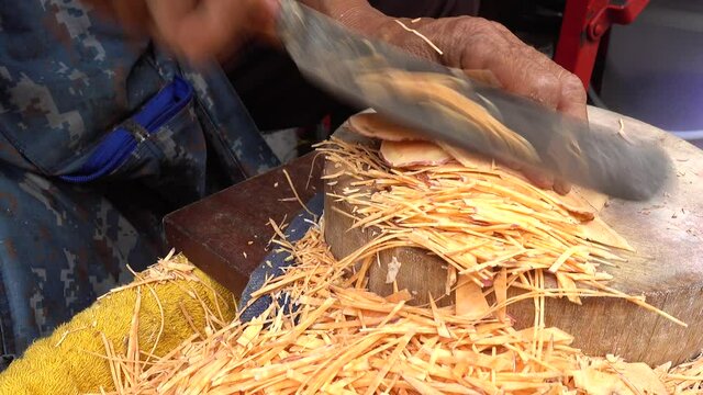 4K Medium Close Up Shot Of Woman Cutting A Sweet Potato Into Thin Slices/Sticks For Homemade Fries