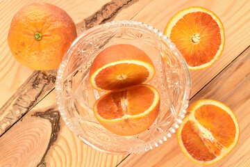 Sweet juicy organic orange, close-up, on a wooden table.