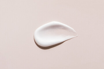 close up of a make up cream on apricot background