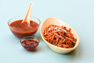 Schezwan Noodles or Manchurian Hakka or vegetable Hakka Noodles or chow mein is a popular indochinese food served in a bowl. Indian Chinese food, selective focus