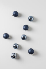 Christmas blue balls on grey. Top view. Xmas abstract pattern. Holiday greeting card.