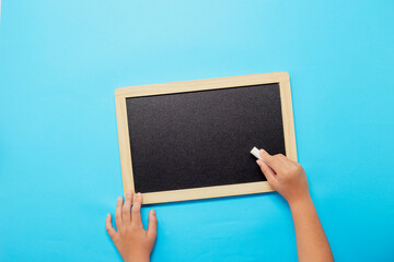 Back to school background, Chalk and hands holding blackboard