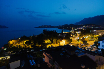 Panorama of city and bay with surrounding landscape at blue hour, Kas, Turkey