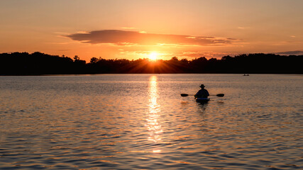 People are boating and having fun under sunset	