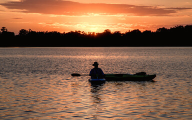 People are boating and having fun under sunset	