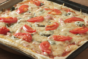 Homemade traditional italian pizza, tomato, mozzarella cheese, bacon.