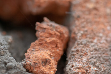 Old broken red brick wall in close-up