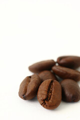 Roasted coffee beans on white background with copy space.