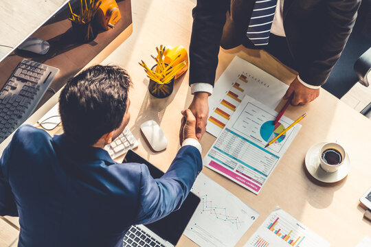 Group Business People Handshake At Meeting Table In Office Together With Confident Shot From Top View . Young Businessman And Businesswoman Workers Express Agreement Of Investment Deal.