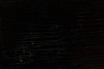 Wooden background of an old lacquered table cracked table.