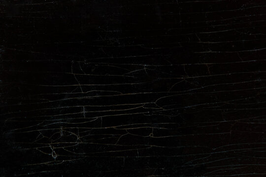 Wooden background of an old lacquered table cracked table.