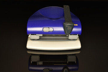 Stationery stapler, close-up, isolated on black background.
