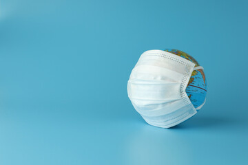 The world simulation with medical mask for stopping the spread of virus on light blue background with copy space. Concept fight against virus.