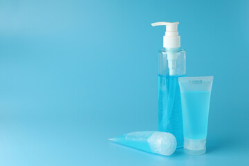 Alcohol gel bottles or hand sanitizer on blue background. This gel cleansers for antibacterial and virus for good sanitation hygiene.