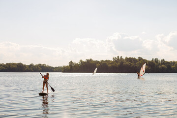 Action Shot of Young Woman on Paddle Board