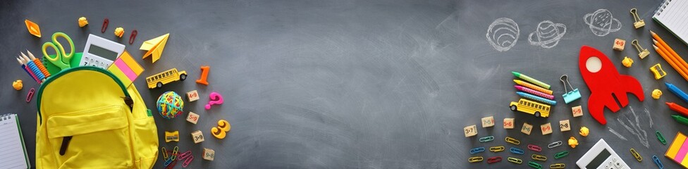 education. Back to school concept. wooden red rocket over blackboard background. top view, flat lay