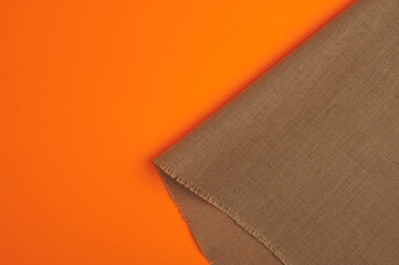 Natural linen texture, orange background.top view