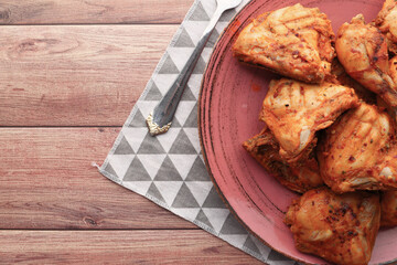 Grilled chicken fillets on plate. top down.