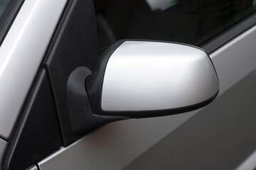 Side view mirror on silver car.