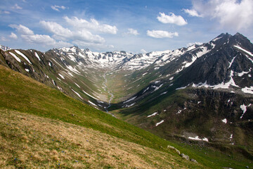 Snowy mountains that begin to melt and become green with spring and around