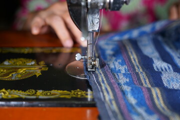 Close up woman hands sewing Traditional prayer mat with old sewing machine