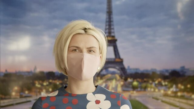 Portrait of a Beautiful Blonde Haired Young Woman Wearing Protective Medical Face Mask and Standing in front of the Eiffel Tower. Safe and Happy Woman Practicing Social Distancing.