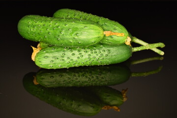 Fresh green cucumbers , close-up, isolated on black.