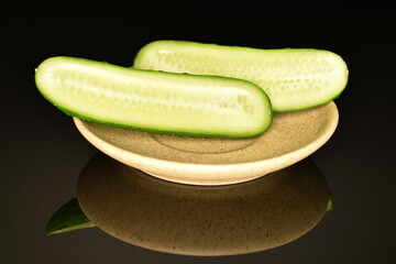 Fresh green cucumbers, close-up, isolated on black.