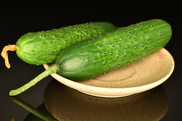 Fresh green cucumbers, close-up, isolated on black.
