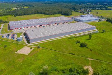 Aerial top view of the large logistics park with warehouse, loading hub with many semi-trailers trucks.