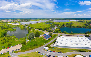 Aerial view of goods warehouse. Logistics center in industrial city zone from above. Aerial view of trucks loading at logistic center