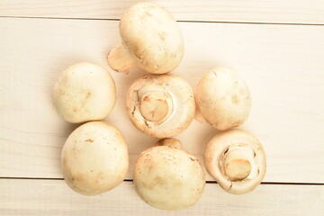 Freshly cut mushrooms, close-up, on a white wooden table.